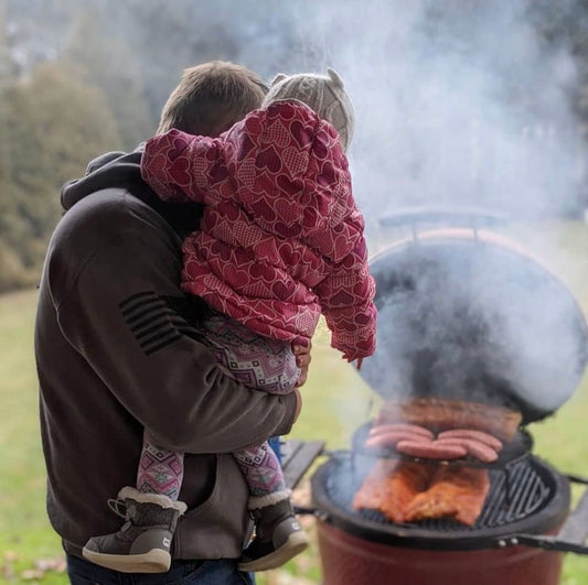 Family using Kamado Joe. Dad and daughter